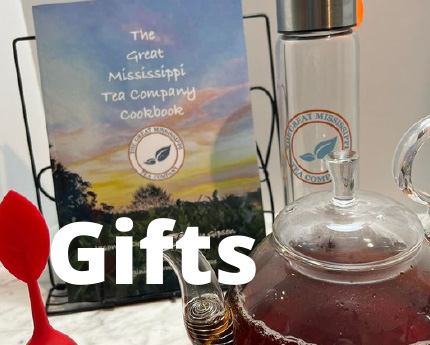picture of a clear glass tea pot, and the great mississippi company's cookbook and a water bottle with the Great Mississippi Tea company's logo